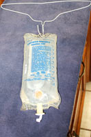 A wire hanger works well for hanging your fluid bag. Place the fluids on a wire hanger.